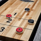 Shuffleboard pucks on a Brunswick Billiards Sanibel 14' Rustic Grey table in zones 1, 2, and 3.