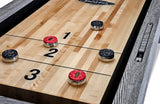 Shuffleboard pucks on a Brunswick Billiards Sanibel 14' Rustic Grey table in zones 1, 2, and 3.