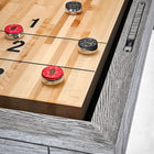 Brunswick Billiards Sanibel 12' Rustic Grey table with four pucks on hardwood playfield.