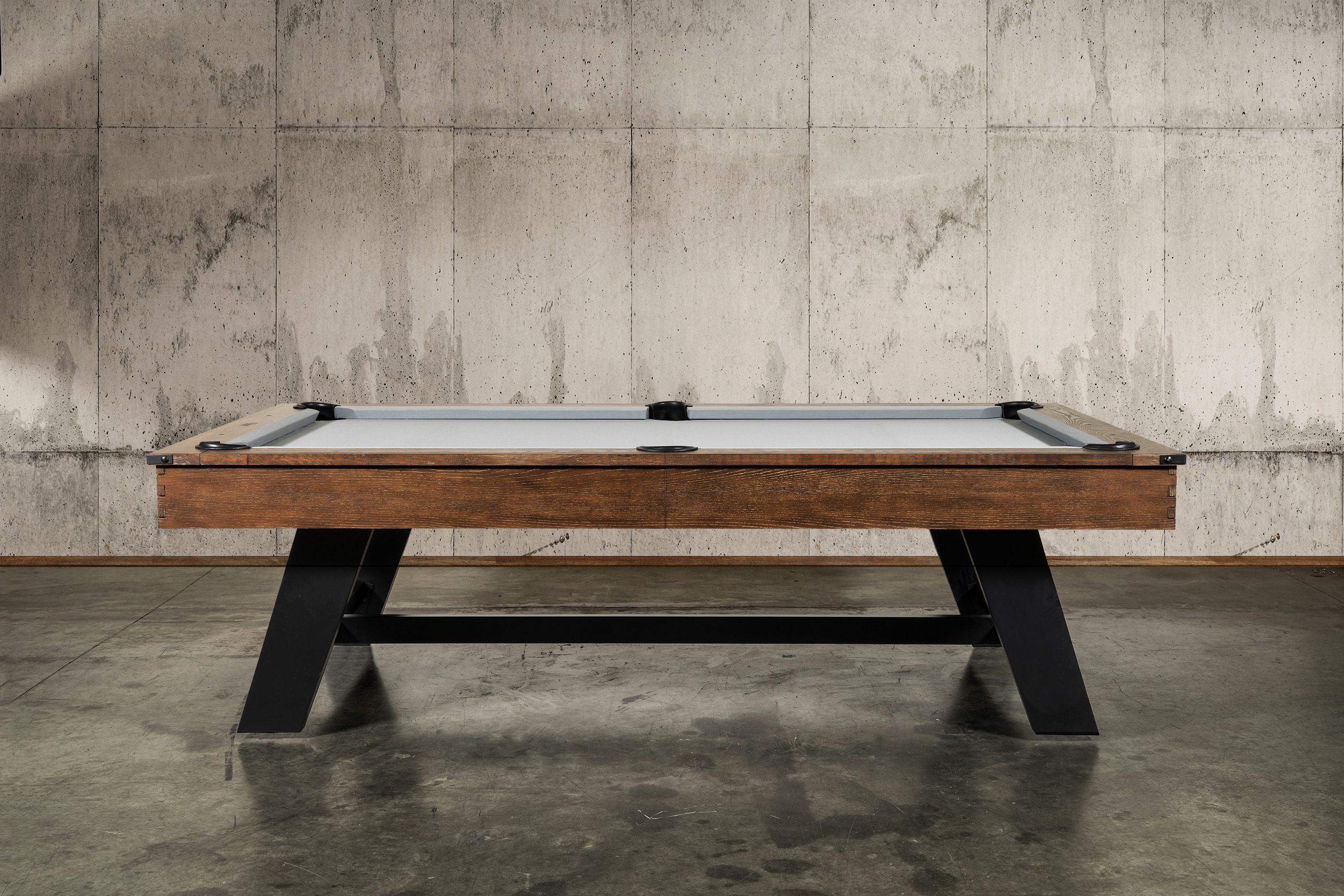 The Nixon Hunter 7' Slate Pool Table in Brushed Walnut adds style with optional dining top.