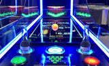 Valley Jet-Pong game by Valley with neon lights, two Corona bottles, and plastic cups behind.