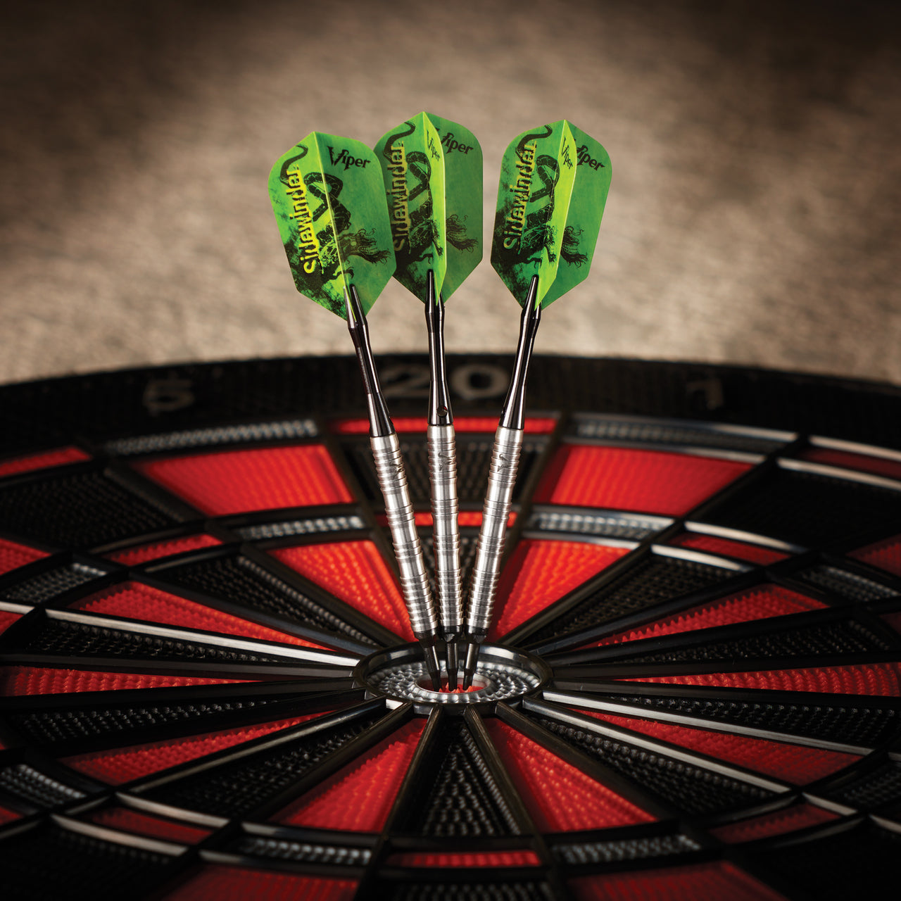 Three Viper Sidewinder tungsten soft tip darts are grouped in the bullseye of a dartboard.