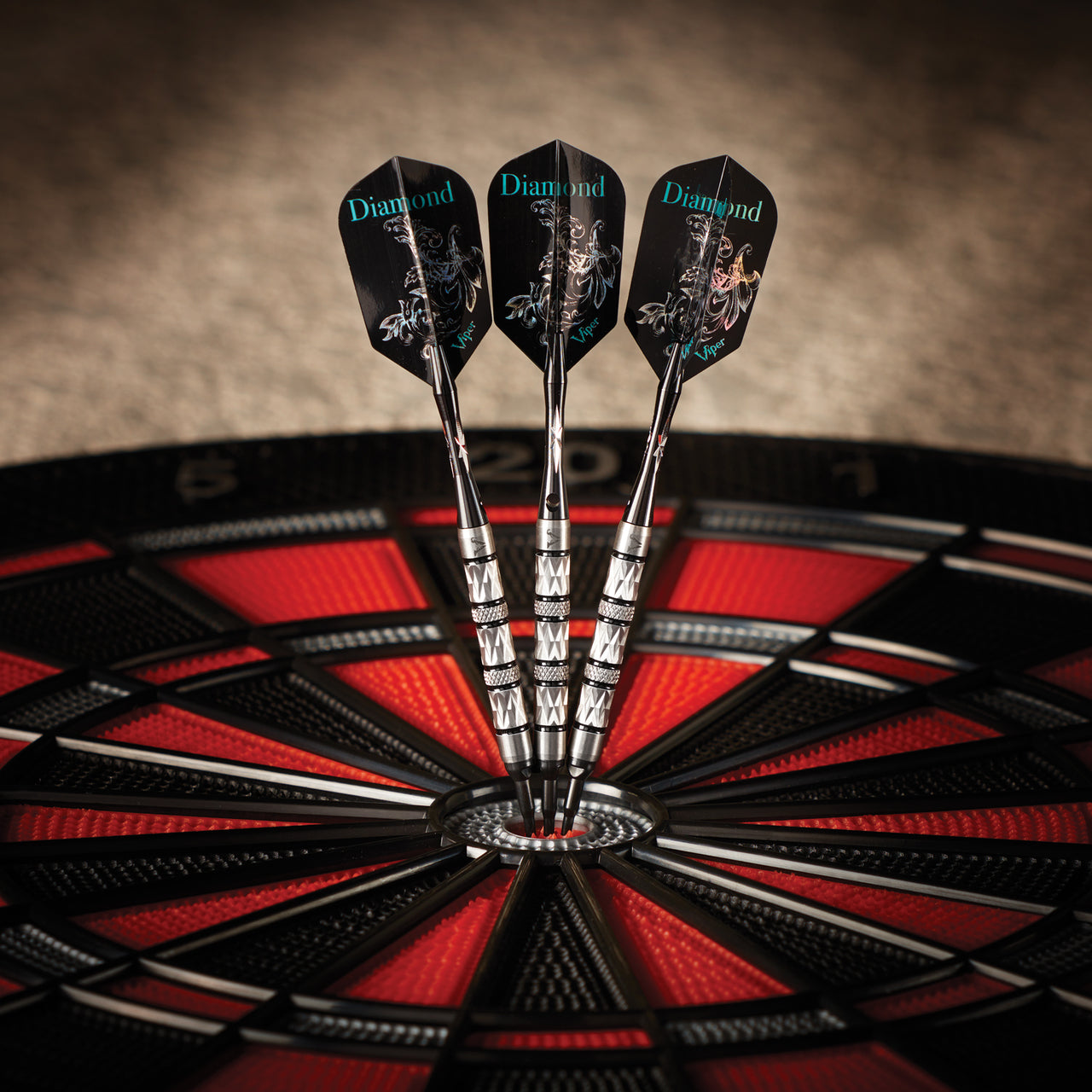 Viper Diamond Tungsten Soft Tip Darts hit the bullseye on a black and red dartboard.