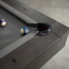The Nixon Georgia 8' Slate Pool Table in Grayson Grey features purple 12 and blue 10 balls nearby.