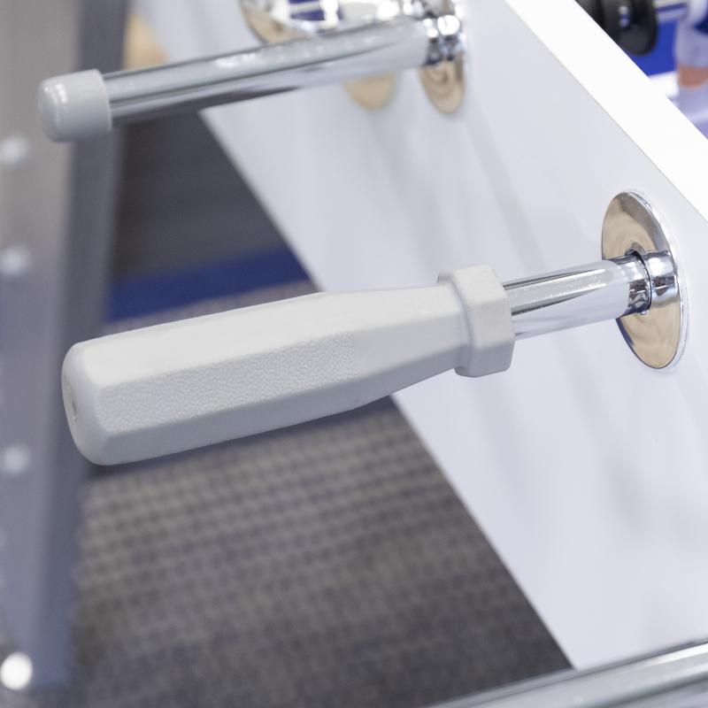 Close-up of a gray handle on the American Legend Manhattan Foosball Table's sleek white panel.