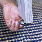 A hand places a leg on a metal protector near an American Legend Manhattan Foosball Table.