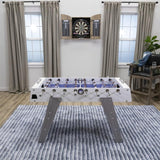 American Legend Manhattan Foosball Table on a rug, with a dartboard mounted on the wall.