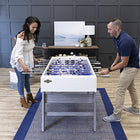 A man and woman playing on an American Legend Manhattan Foosball Table.