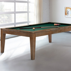 The Brunswick Billiards Loft 8' Slate Pool Table with cues and balls in a bright, modern room.