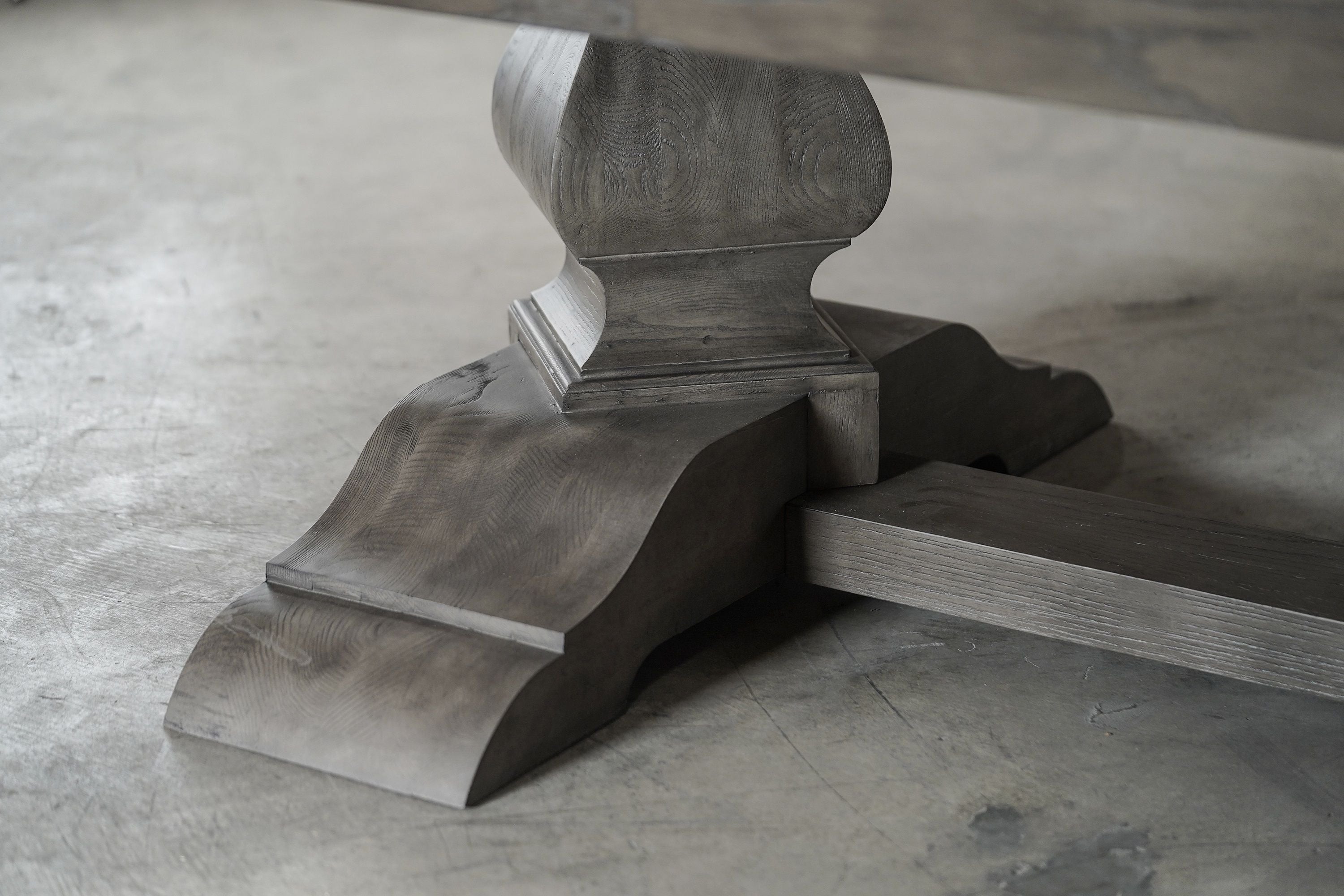 Close-up of a Nixon Billiards Birdy 7' Slate Pool Table leg in Grayson Grey on concrete floor.