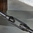 Close-up of a metal turnbuckle on the Brunswick Billiards Canton 14' Shuffleboard Table.