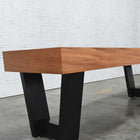 A Venture Monaco 18' Shuffleboard Table with black metal legs sits on a concrete floor.