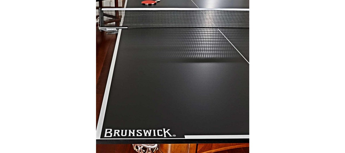 A Brunswick Billiards OAKLAND II 8' Pool Table stands on a wood floor, cues and balls ready.