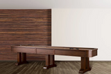 The American Heritage Billiards Milan 14' Shuffleboard Table in Navajo stands on wood flooring.