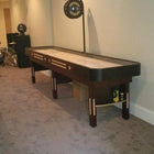 Champion 9' The Grand Champion Shuffleboard Table by Champion with overhead electronic scoreboard.