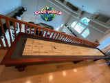 Playcraft St. Lawrence 16' Shuffleboard Table in Chestnut beneath Game World Planet sign.