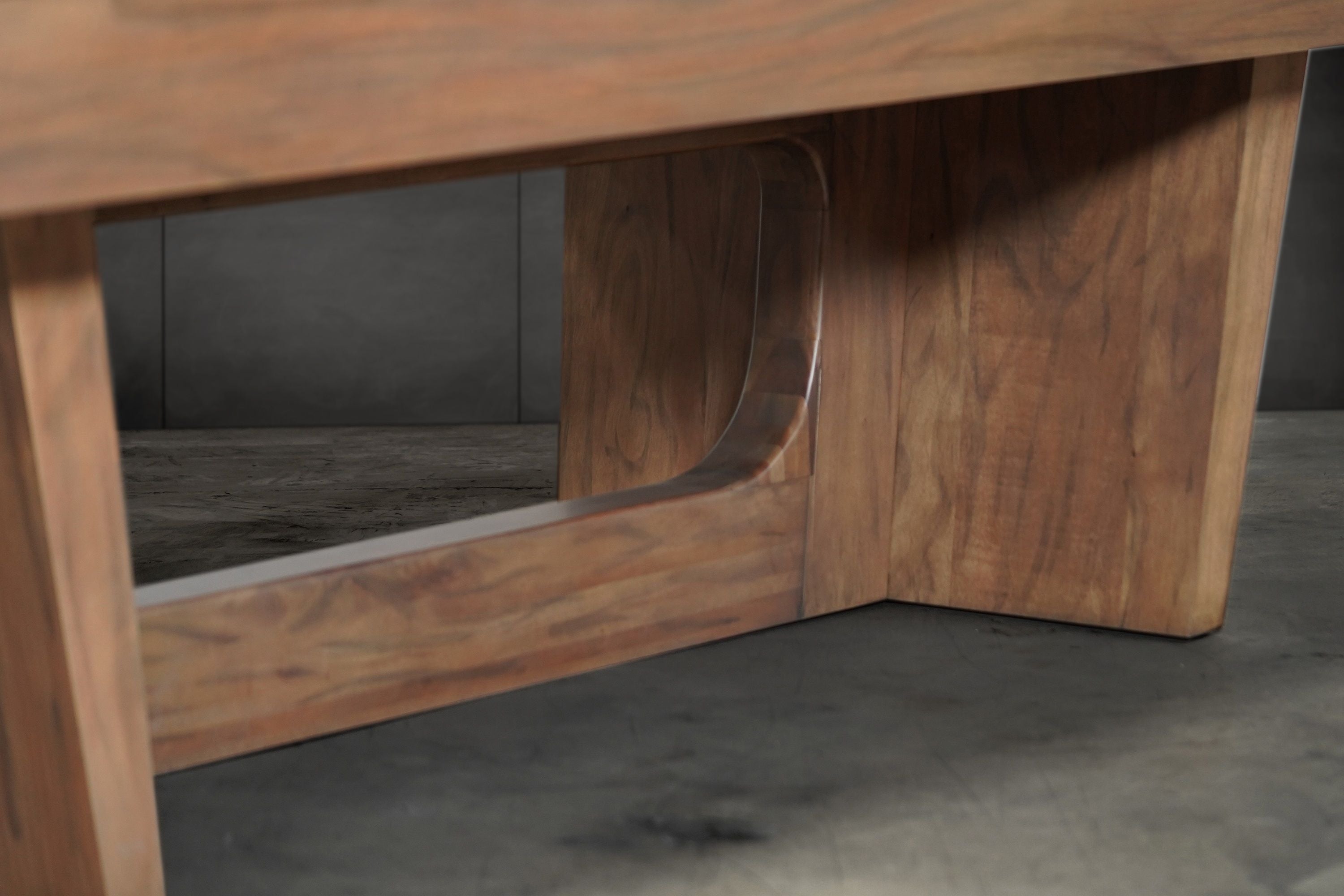 Close-up of Nixon KAI 7' Slate Pool Table legs in walnut finish by Nixon Billiards on concrete.