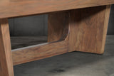 Close-up of Nixon KAI 7' Slate Pool Table legs in walnut finish by Nixon Billiards on concrete.