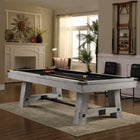 Modern living room with a Playcraft Yukon River slate pool table in Northern Drift and two chairs.