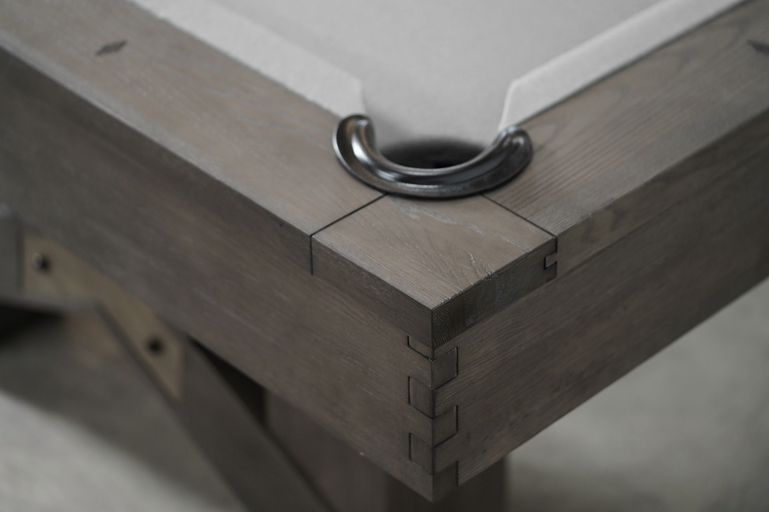 Close-up of Nixon Georgia 8' pool table in Grayson Grey by Nixon Billiards, black pocket visible.