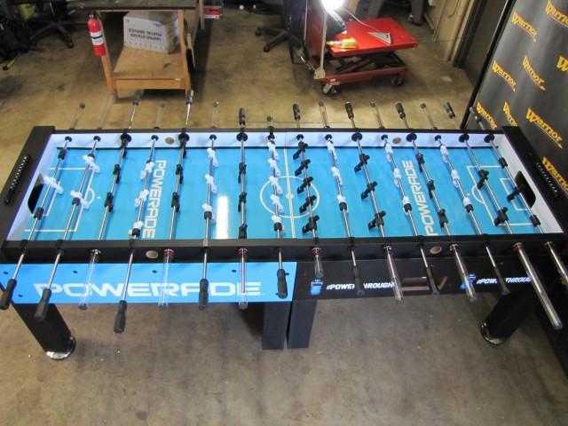 Warrior 8 Players Foosball Table with split bearing in a workshop filled with tools.