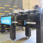 Warrior 8 Players Foosball Table with split bearing, shown in front of a Warrior banner.