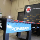 Warrior 8 Players Foosball Table with rod guard, indoor setting, and Warrior banner.