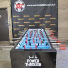 A Warrior 8 Players Foosball Table sits before a branded Warrior Table Soccer banner.