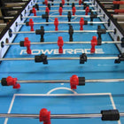 A close-up of the Warrior 8 Players Foosball Table with rod guard and red/black players on blue.