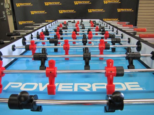Close-up of Warrior 8 Players Foosball Table with split bearing and Warrior branding on surface.