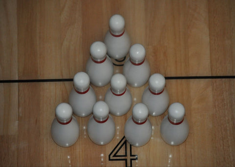 Ten Playcraft 4-1/2" solid wood bowling pins are set up in a triangle on lane 4.