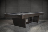 Nixon KAI 7' Slate Pool Table in Waxed Brown by Nixon Billiards shown on a concrete floor.