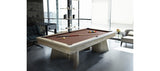 A modern room with a Brunswick Billiards Sagrada 8' Slate Pool Table in Sandwashed and cue stick.