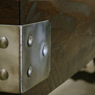 Close-up of a Venture Williamsburg 12' Shuffleboard Table metal bracket with rivets.