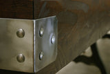 Close-up of a Venture Williamsburg 12' Shuffleboard Table metal bracket with rivets.